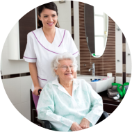 Nurse helping to old woman in wheelchair