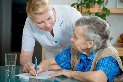 Assisting a senior woman by nurse at home